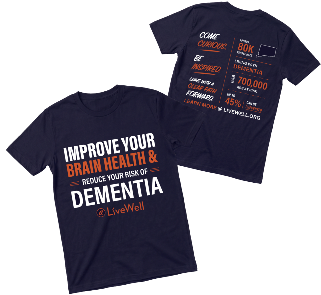 Navy T‑shirt with bold white and orange text promoting brain health: 'Improve your brain health & reduce your risk of dementia' and LiveWell branding.