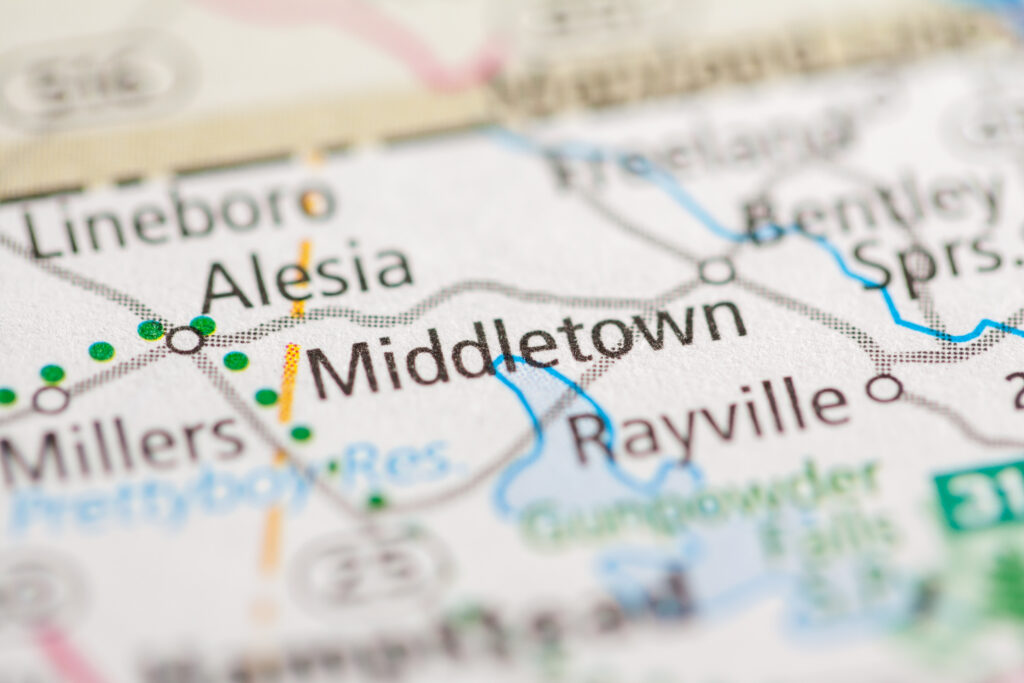 Close-up of a printed map section highlighting Middletown and nearby towns; a blue river runs through the area.